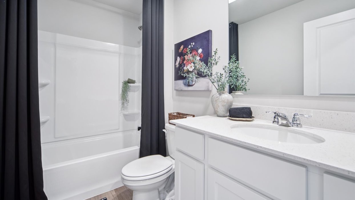 Stylish full bathroom with bright lighting and functional design.