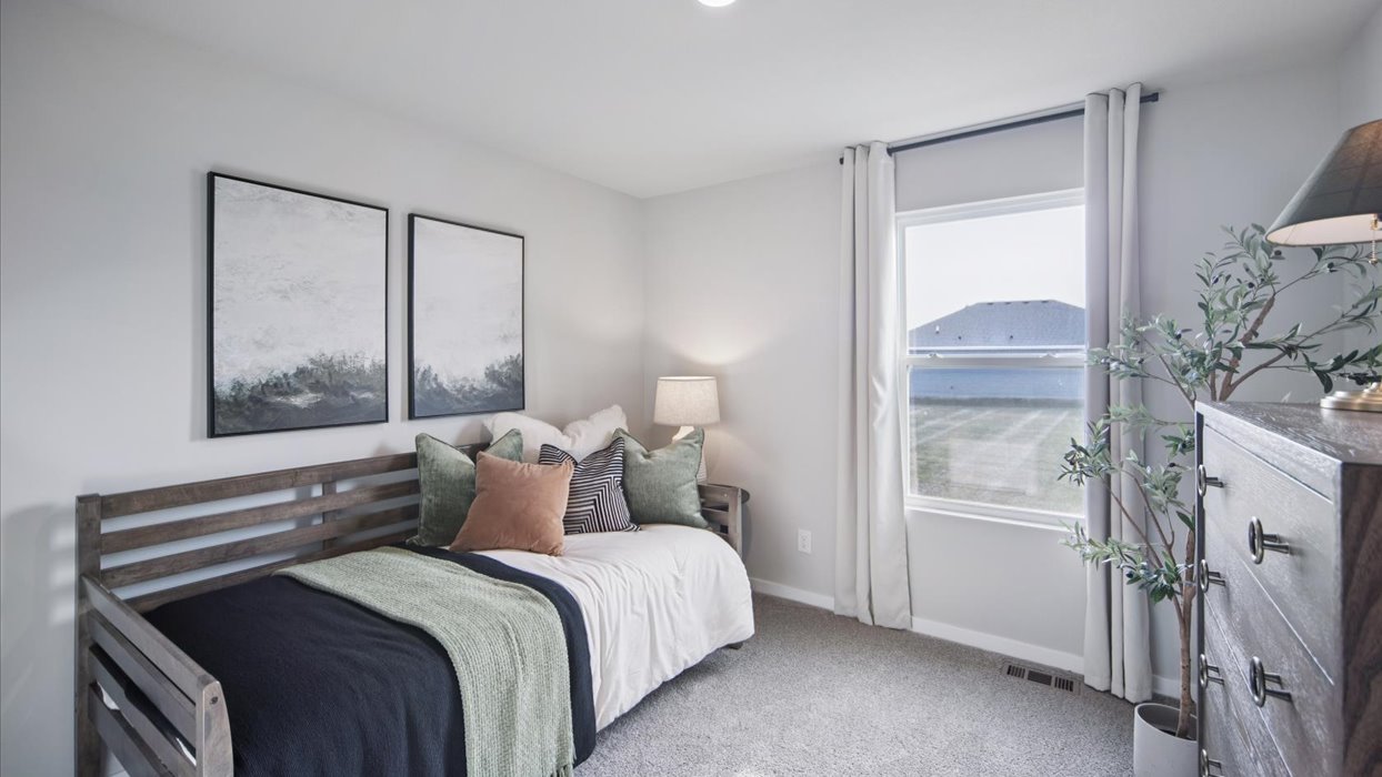 Comfortable secondary bedroom with natural light, modern finishes, and versatile living space.