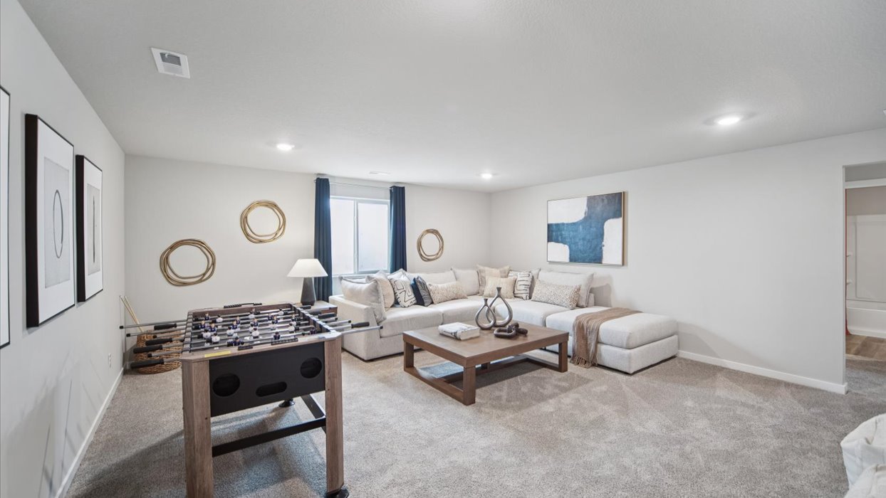 Finished basement living area with comfortable seating space and flexible room for entertaining or relaxing.
