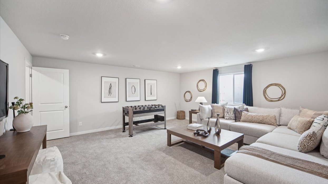 Finished basement living area with comfortable seating space and flexible room for entertaining or relaxing.