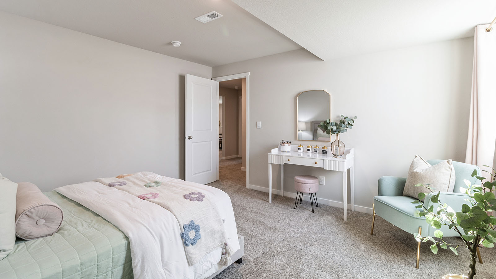 Private lower-level bedroom with natural light and functional storage space.
