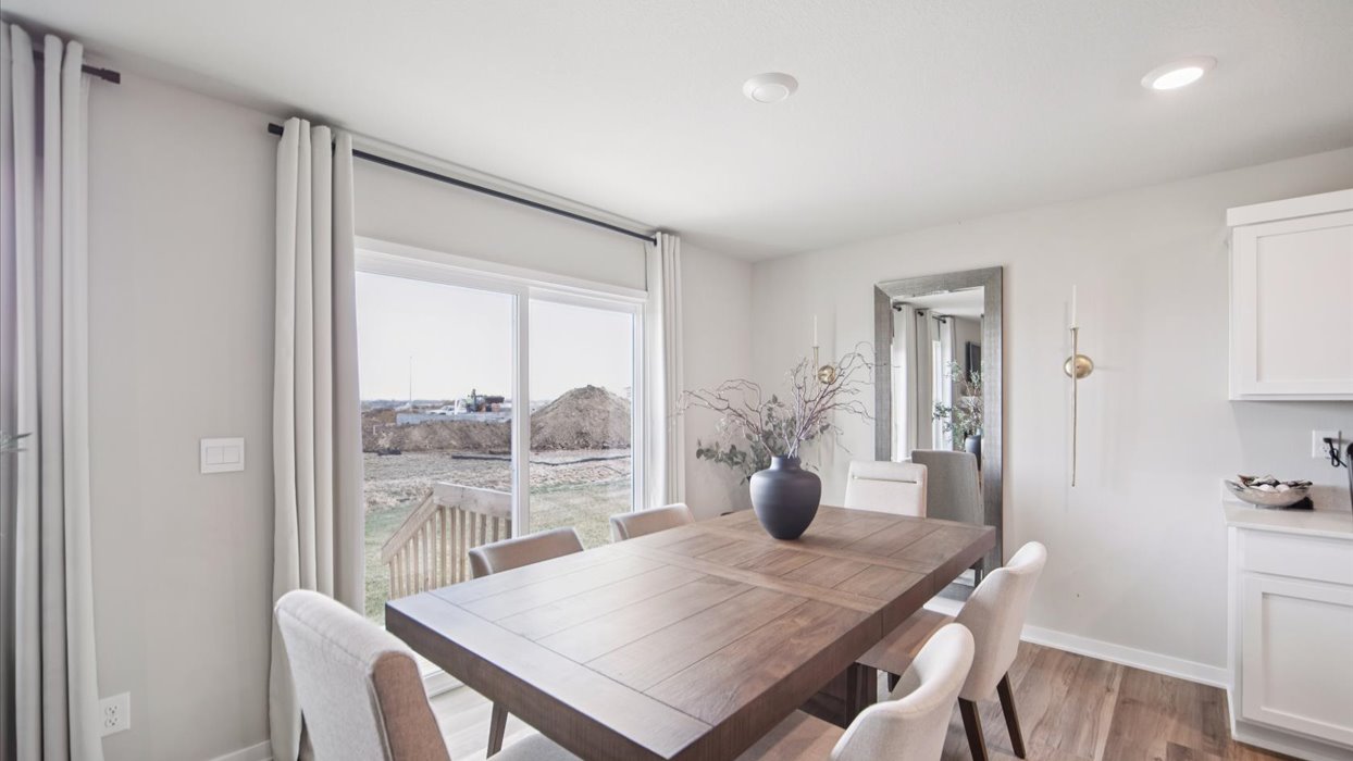 Open concept dining space with access to backyard