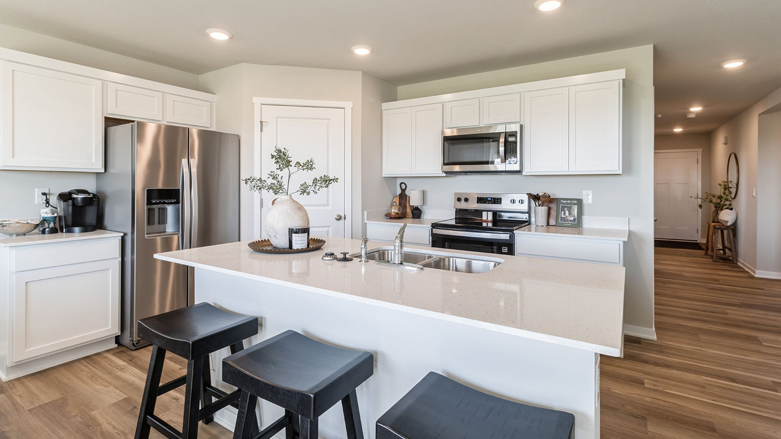Kitchen with white cabinetry and quartz countertop