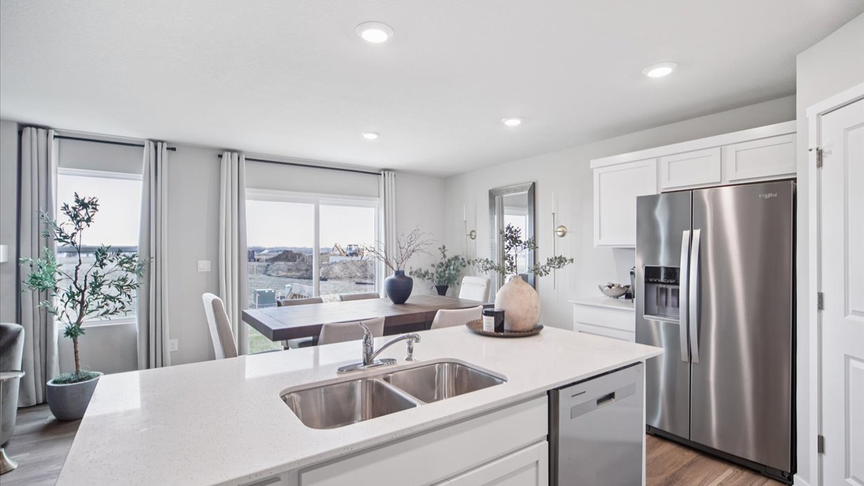 Kitchen with white cabinetry and quartz countertop