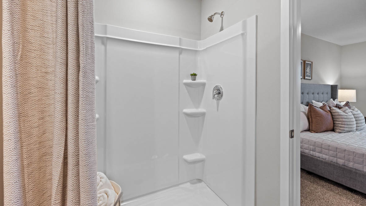 Shower with shelves in primary bathroom