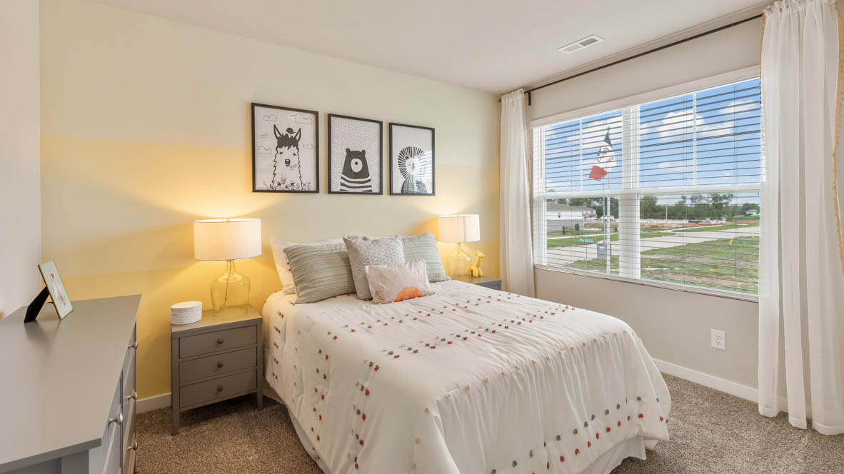 Third bedroom in the Bellhaven with a queen bed and a nightstand with white sheets