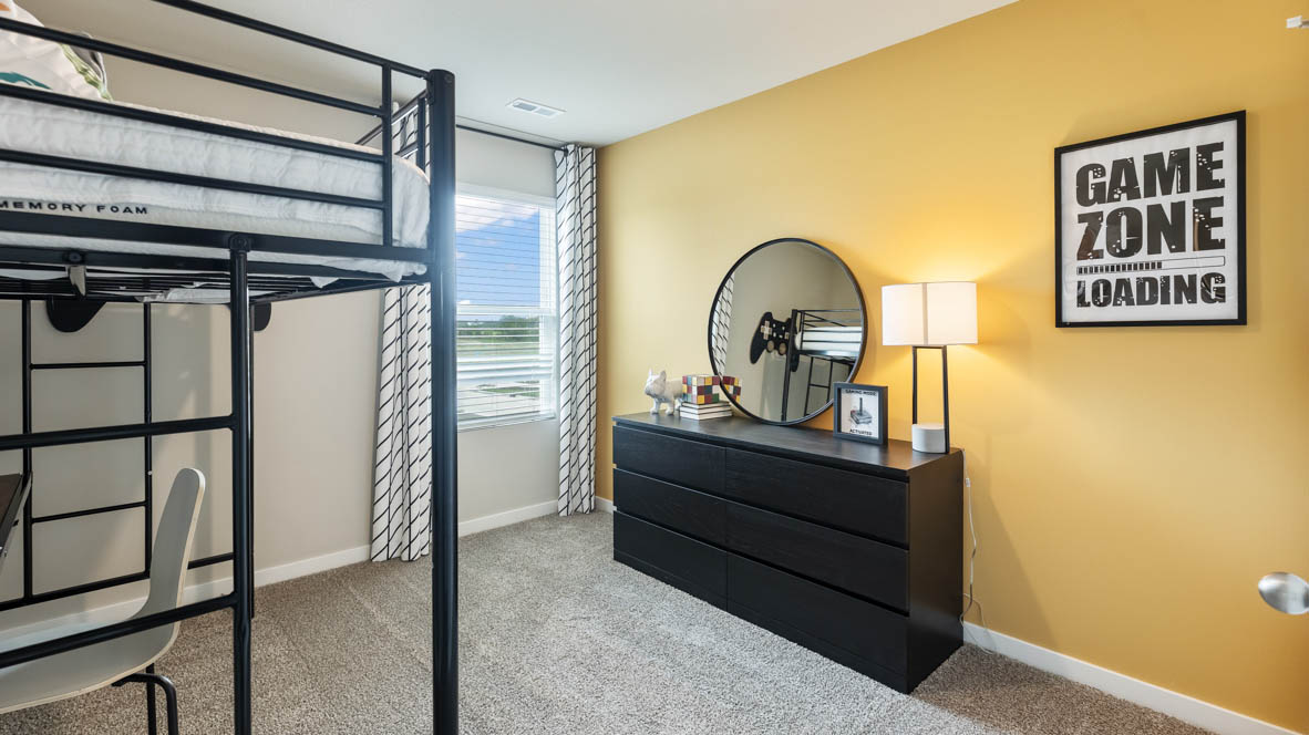 Fourth bedroom in the Bellhaven with bunkbeds, a dresser and mirrow