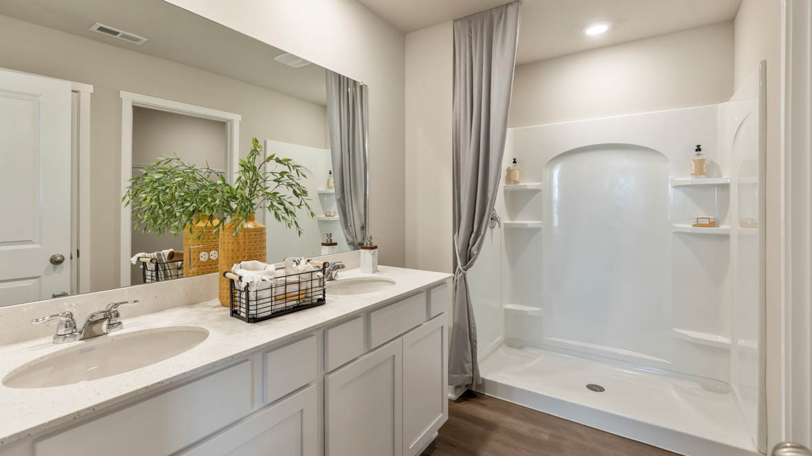 Primary bathroom of the Bellhaven with a dual sink and walk in shower