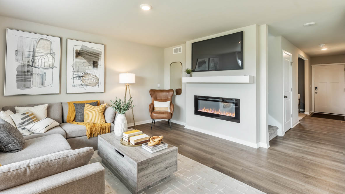 Bellhaven living room showcasing the fireplace with a sectional, coffee table and a chair in the corner