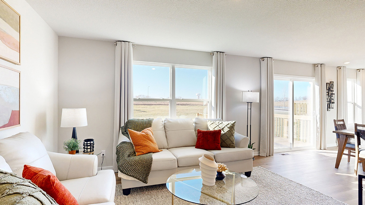 Open living room with brown flooring.