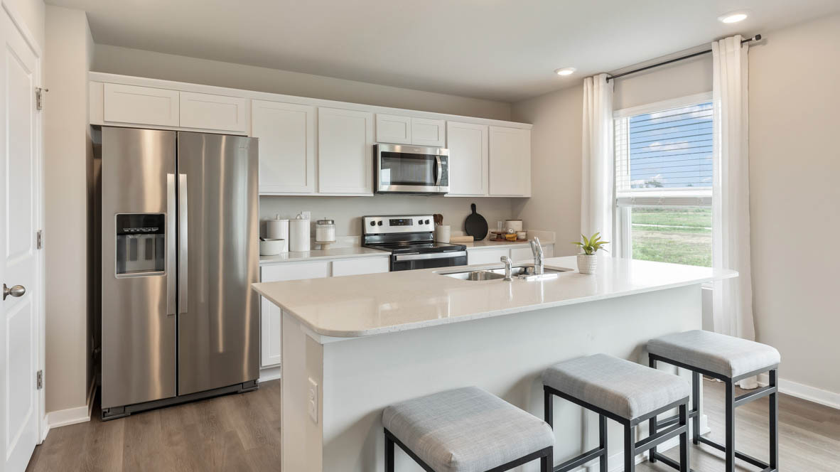 Bellhaven kitchen with white cabinets and a kitchen island with 2 chairs