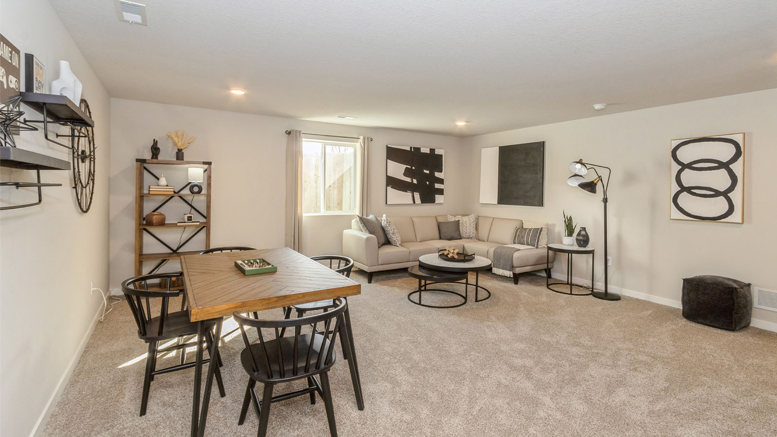 spacious finished basement with dining table and small white couch