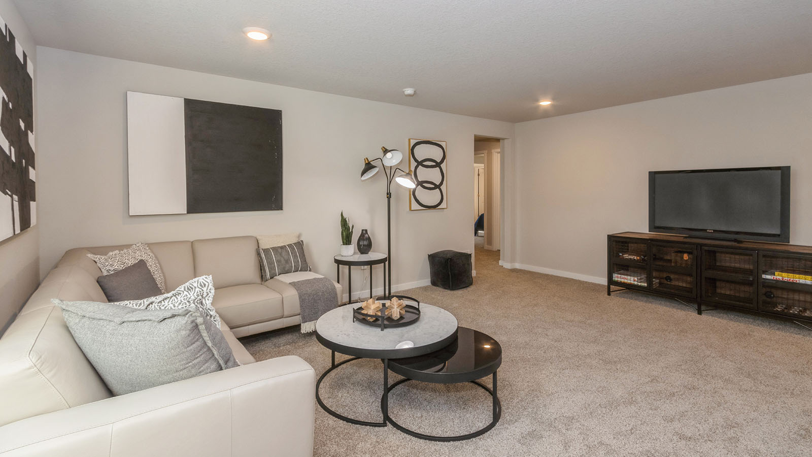 finished basement with white couch and coffee table
