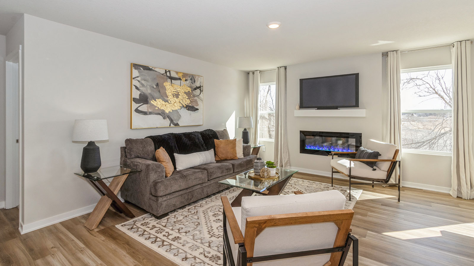 bright hamilton living room with two small windows and electric fireplace