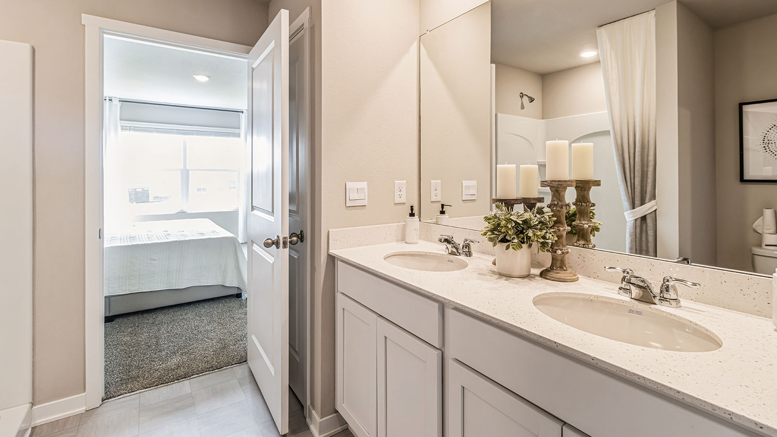 Spacious primary bathroom featuring dual vanities, modern fixtures, and a walk-in shower.