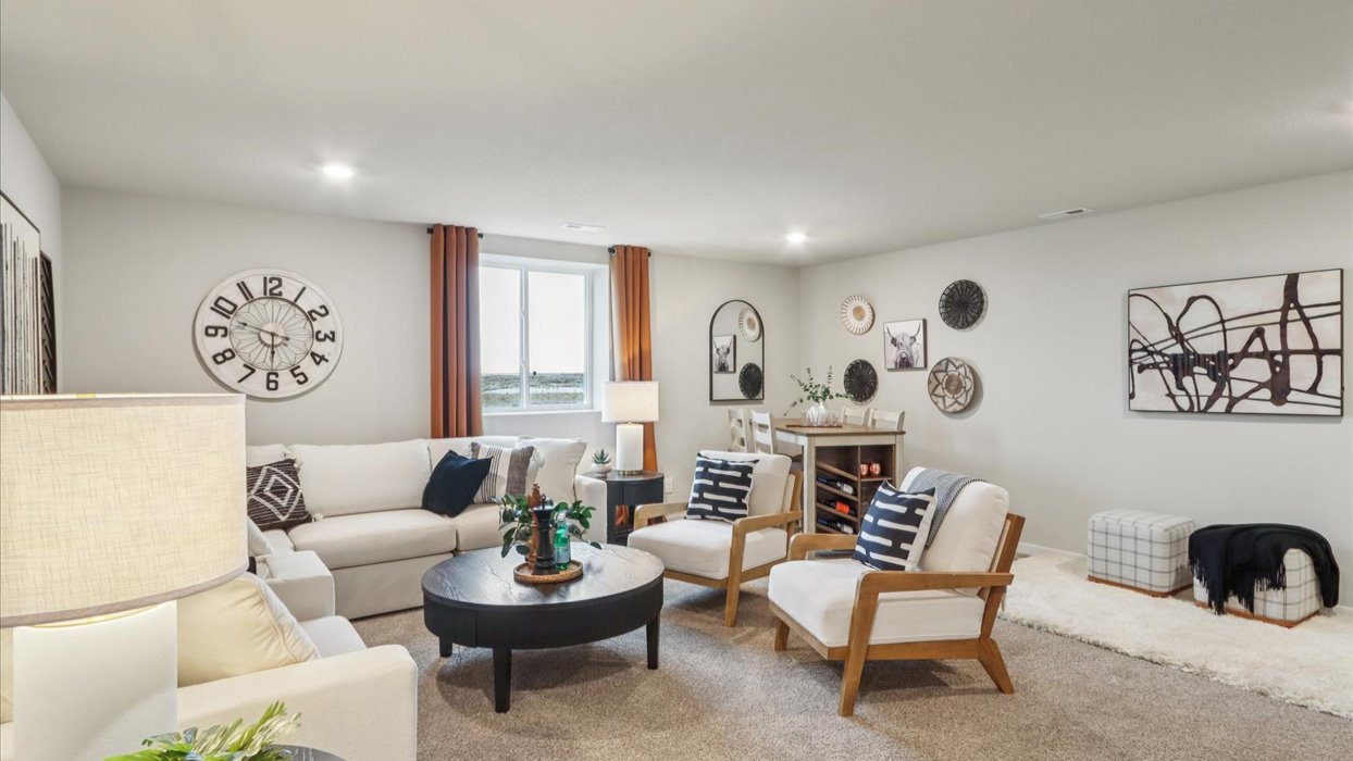 Finished basement living area with comfortable seating space and flexible room for entertaining or relaxing.
