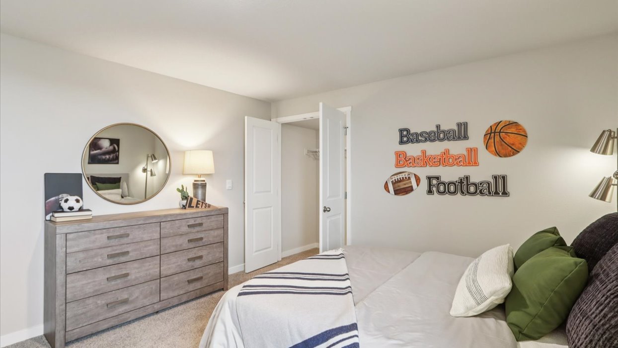 Private lower-level bedroom with natural light and functional storage space.