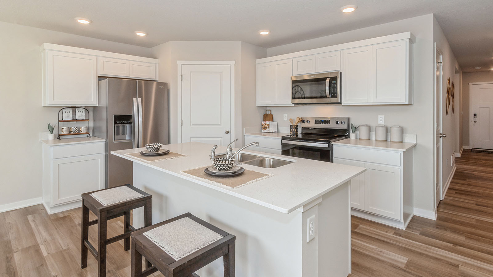 modern kitchen with white cabinetry and stainless steel appliances