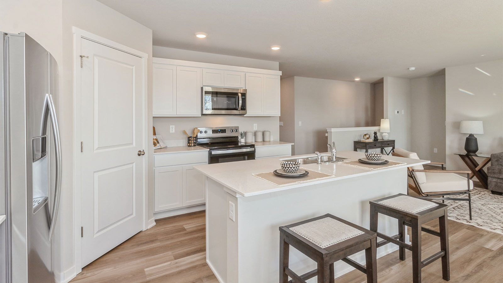side view of kitchen with walk in pantry and quartz countertops