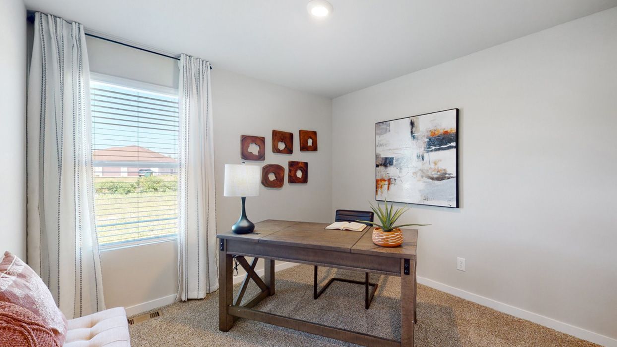 Third bedroom of the Aldridge staged as a desk with a chair