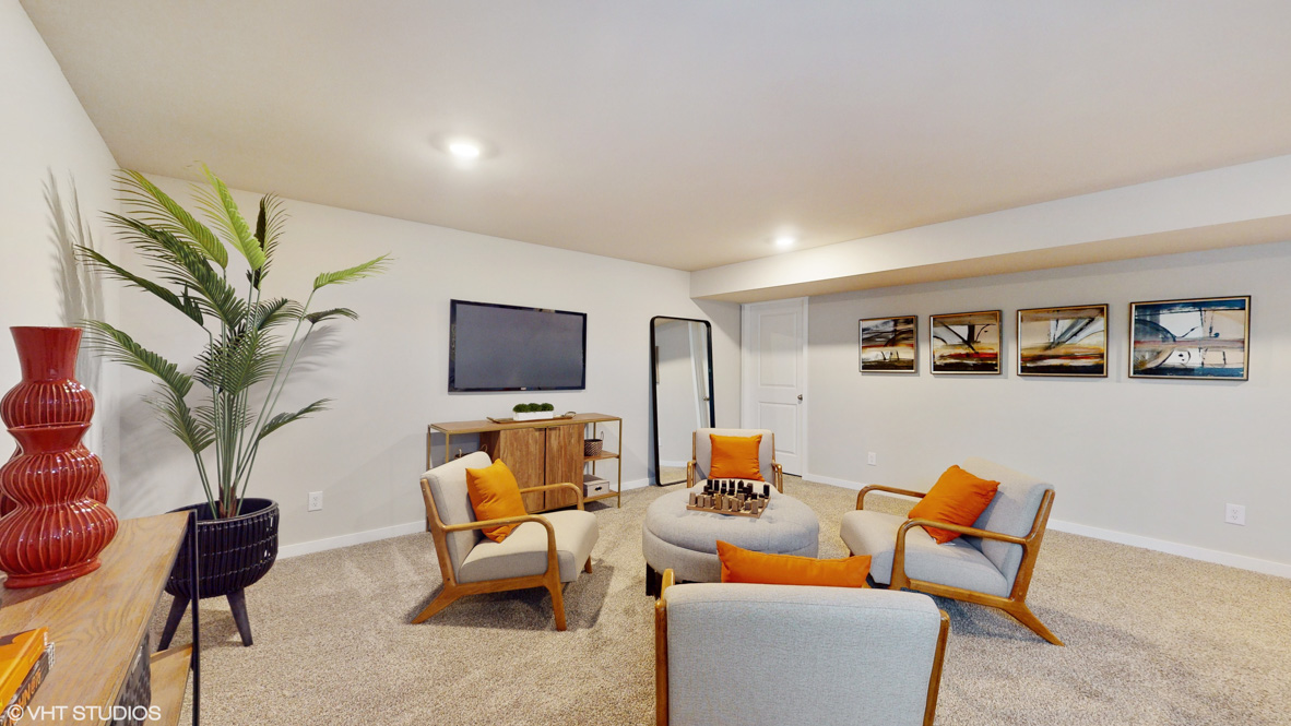 Finished basement living area with comfortable seating space and flexible room for entertaining or relaxing.