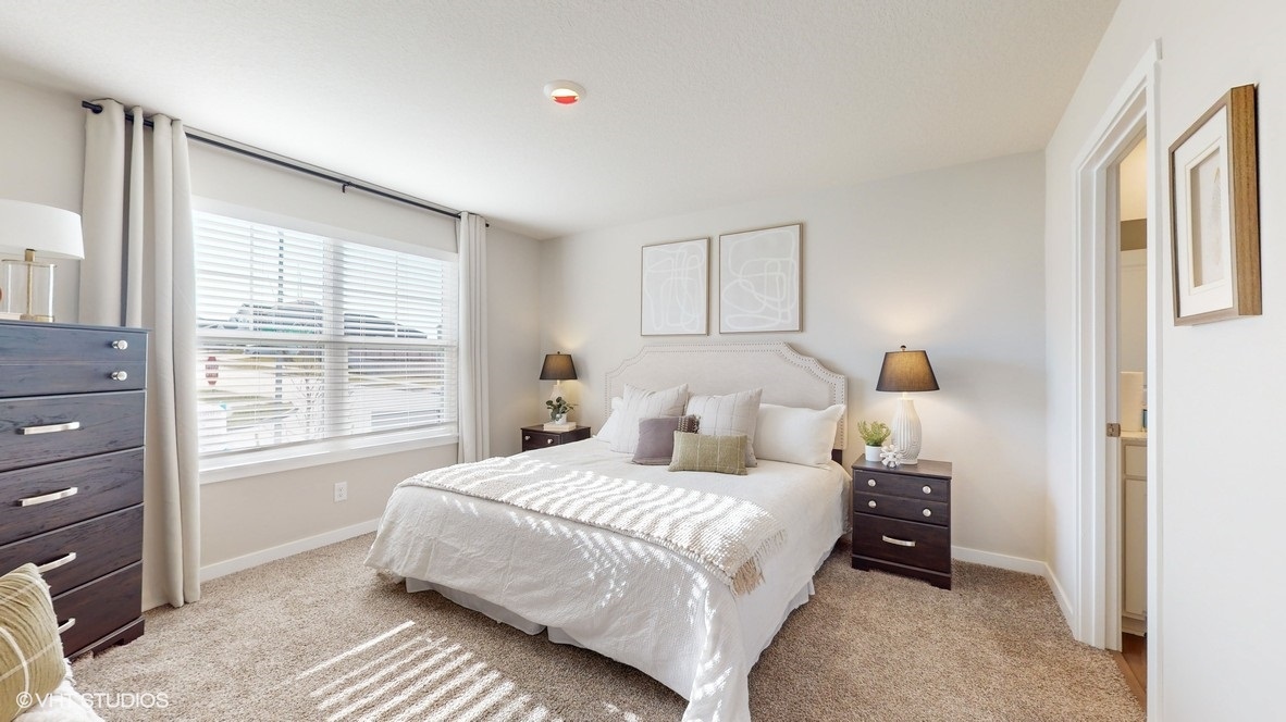 Primary bedroom with natural lighting and spacious layout