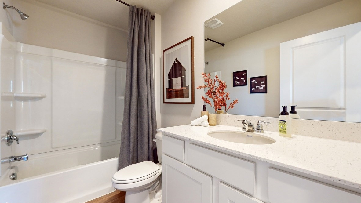 Stylish full bathroom with bright lighting and functional design.
