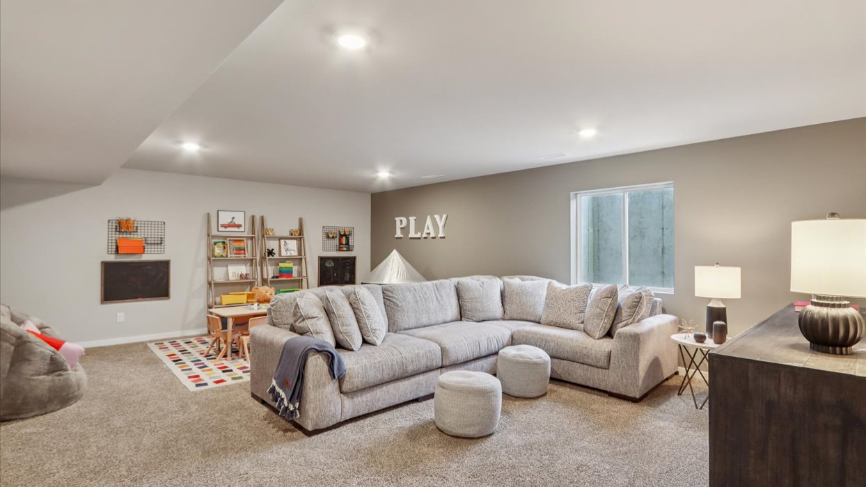 Finished basement living area with comfortable seating space and flexible room for entertaining or relaxing.