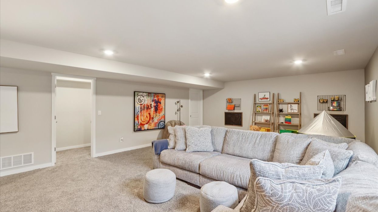 Finished basement living area with comfortable seating space and flexible room for entertaining or relaxing.