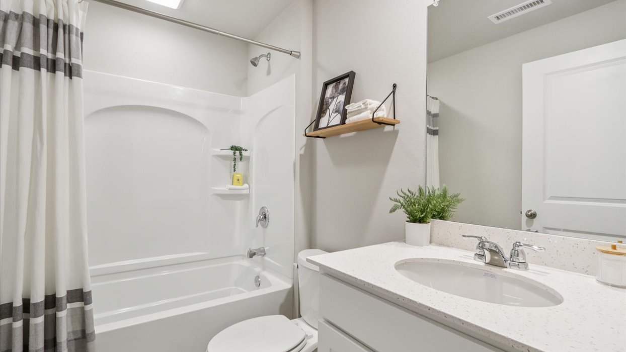 Stylish lower-level bathroom featuring contemporary fixtures and convenient access from the finished basement.