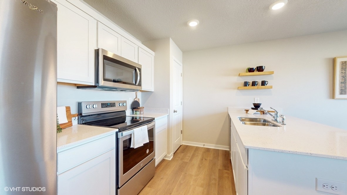Kitchen with white cabinetry and quartz countertop