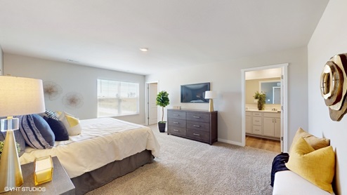 Sydney primary bedroom with king bed, dresser and view of the primary bedroom and closet