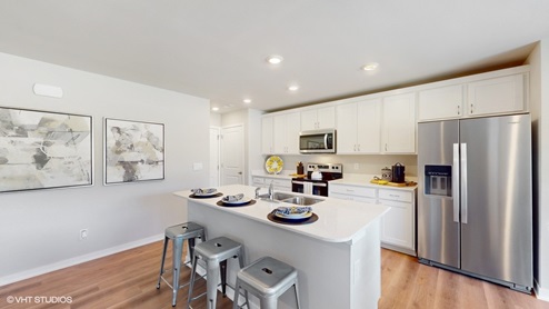 Kitchen of the Sydney with white cabinets and a spacious island