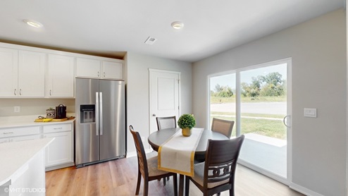 Dining room of the sydney with a view of sliding glass doors and kitchen