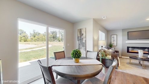 Dining room in the Sydney with sliding glass doors and view into the living room