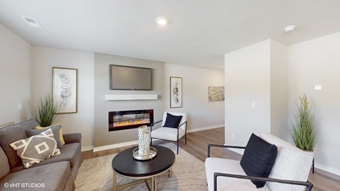 Living room of the Sydney with a couch and coffee table around a firplace