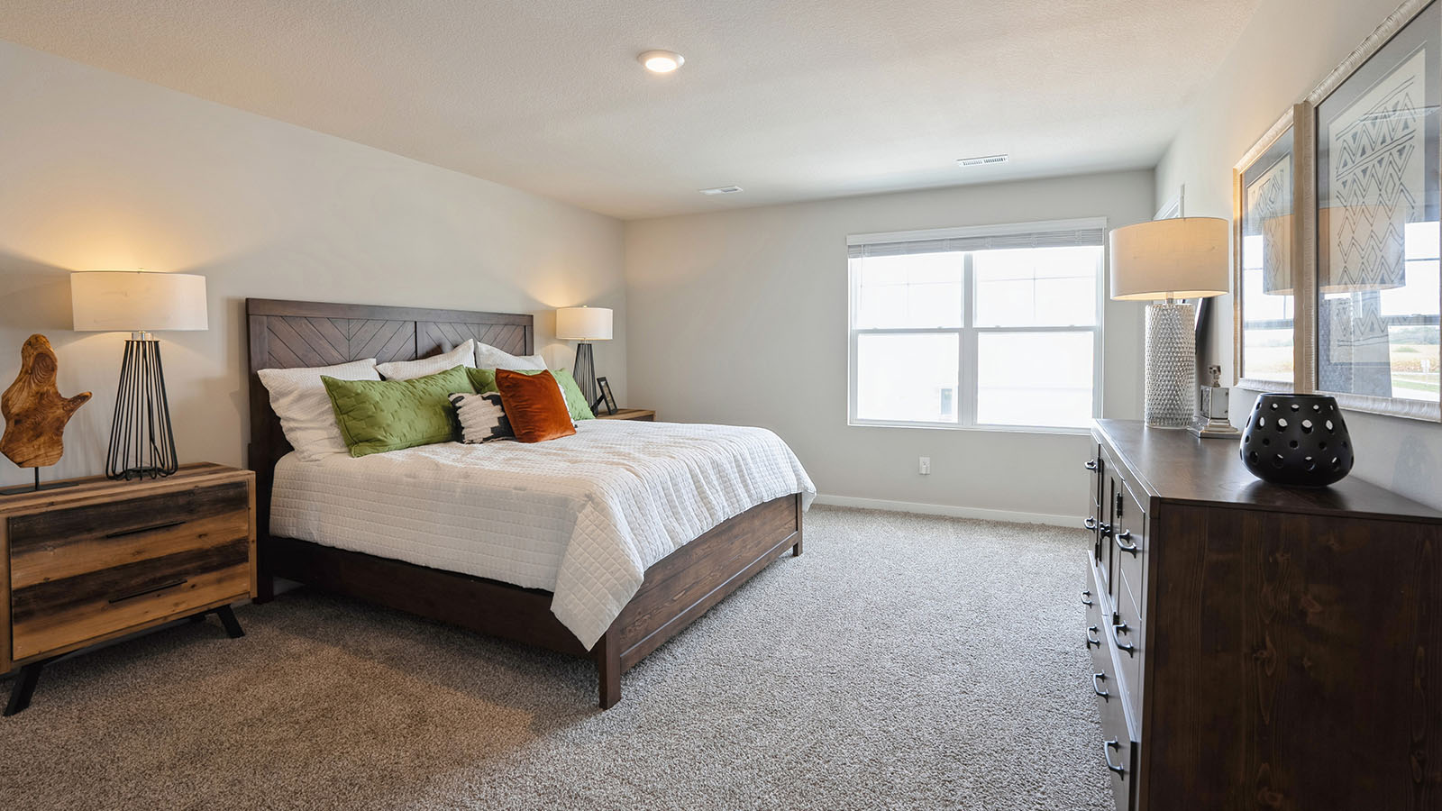 bedroom with beige carpet, white walls and a window