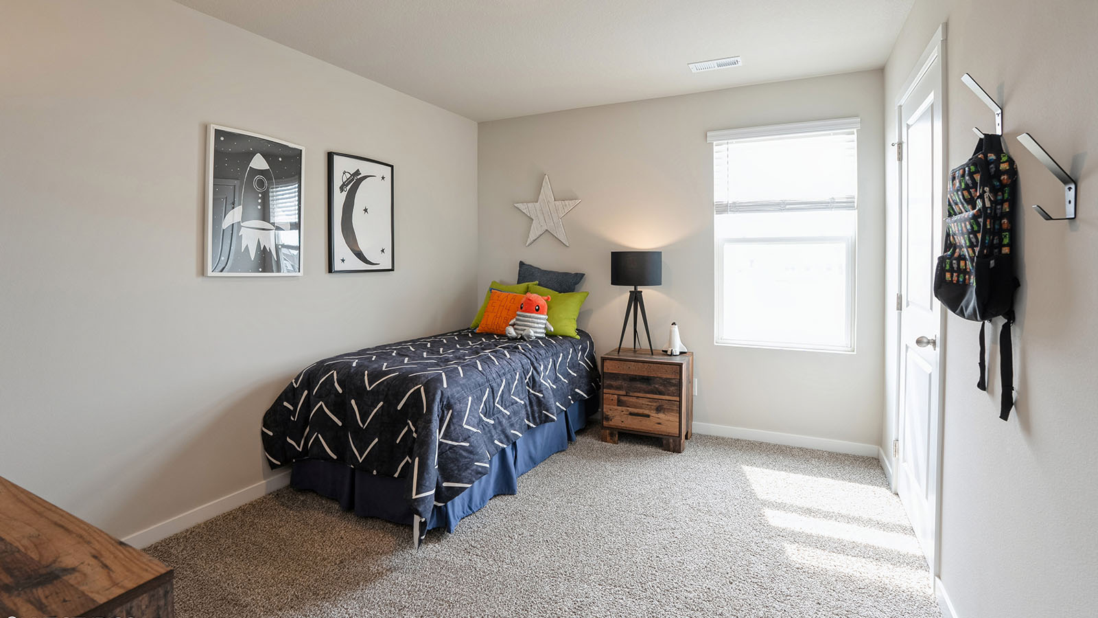 bedroom with beige carpet, white walls and a window