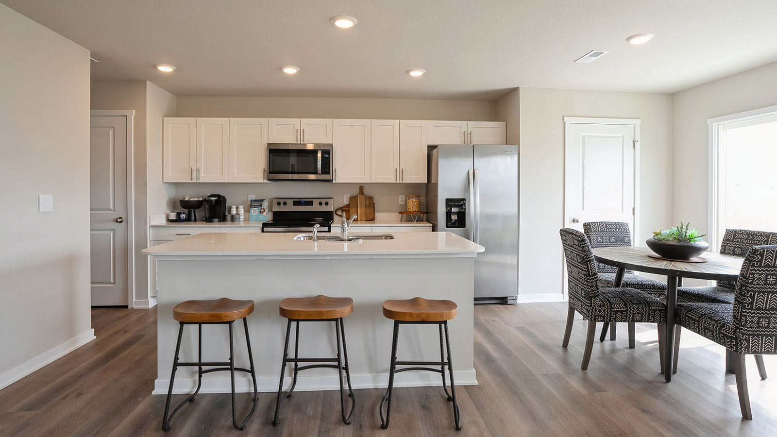 kitchen with white cabinetry, large island, and stainless steel appliances