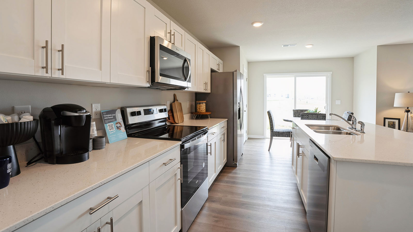 kitchen with white cabinetry, large island, and stainless steel appliances