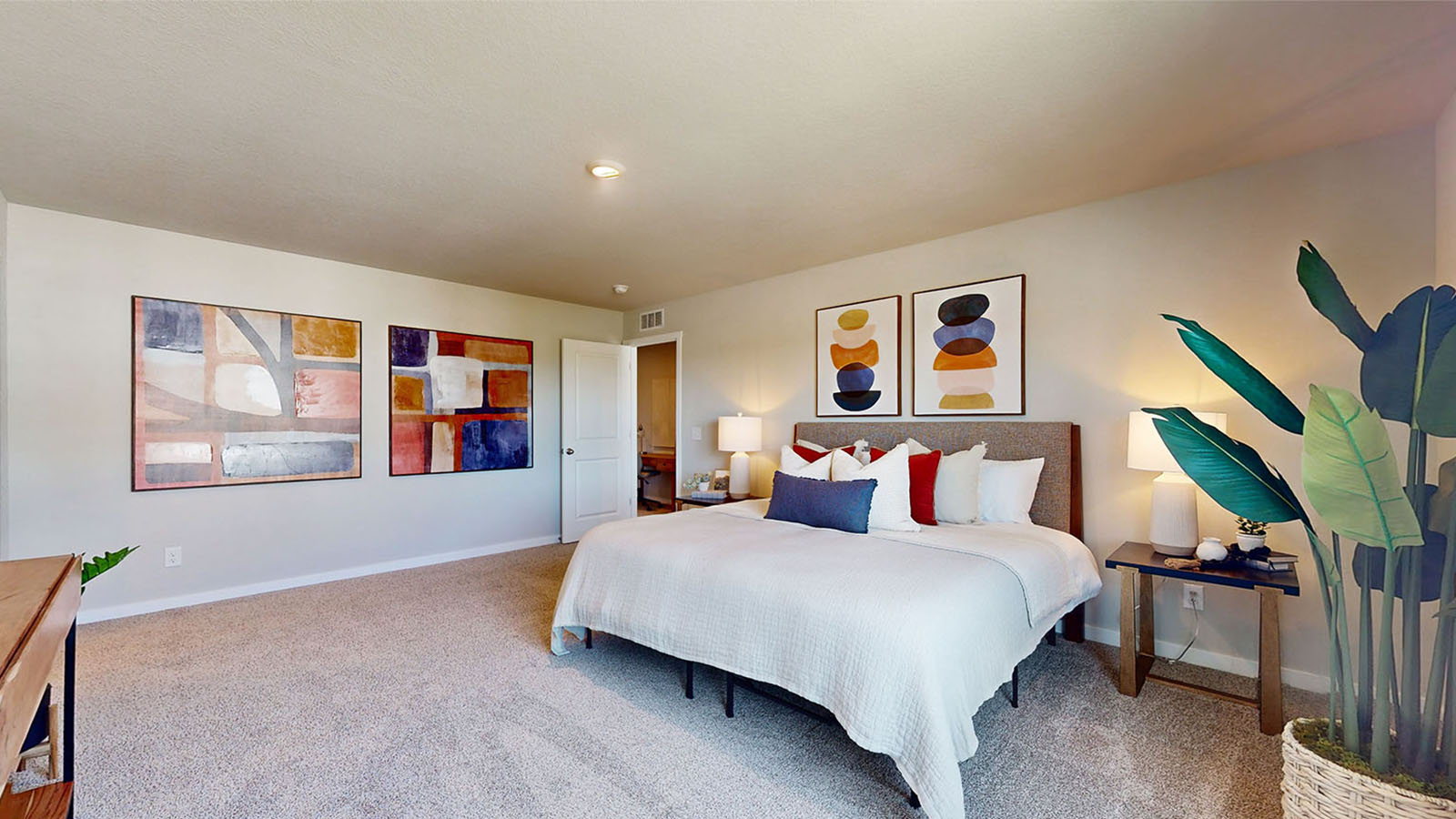 bedroom with beige carpet, white walls and a window