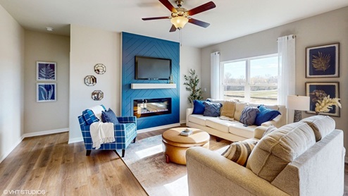 bright living room with black accent wall and electric fireplace