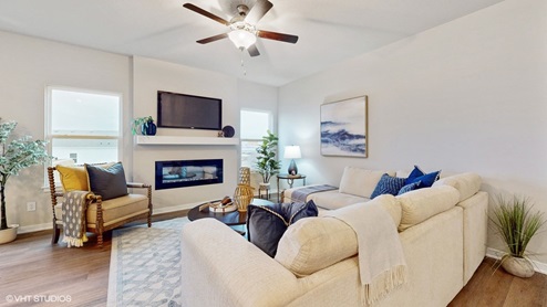bright living room with two windows and overhead fan