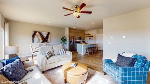 living room with wood ceiling fan and couches