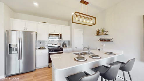 Kitchen with modern light fixture and stainless steel appliances