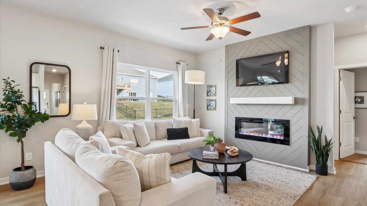 bright aldridge living room with green accent wall and electric fireplace