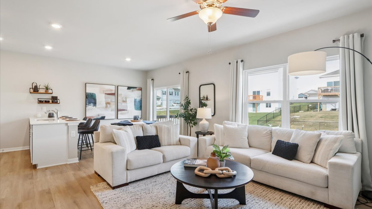 open concept living room and dining area with overhead lighting