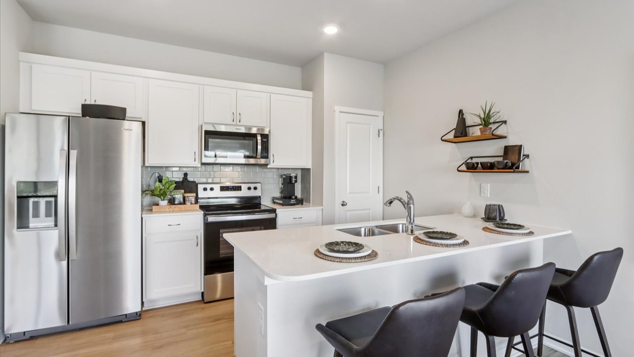 modern kitchen with white cabinets and island