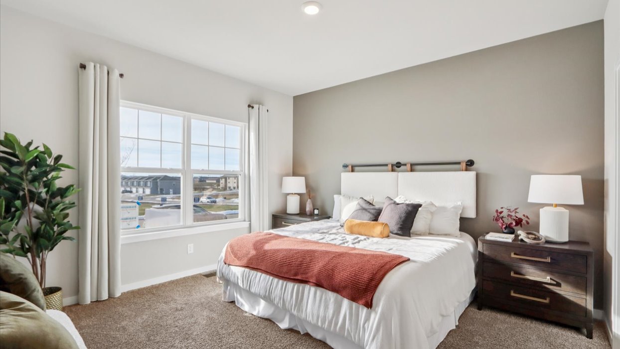 large primary bedroom with white bed and nightstands