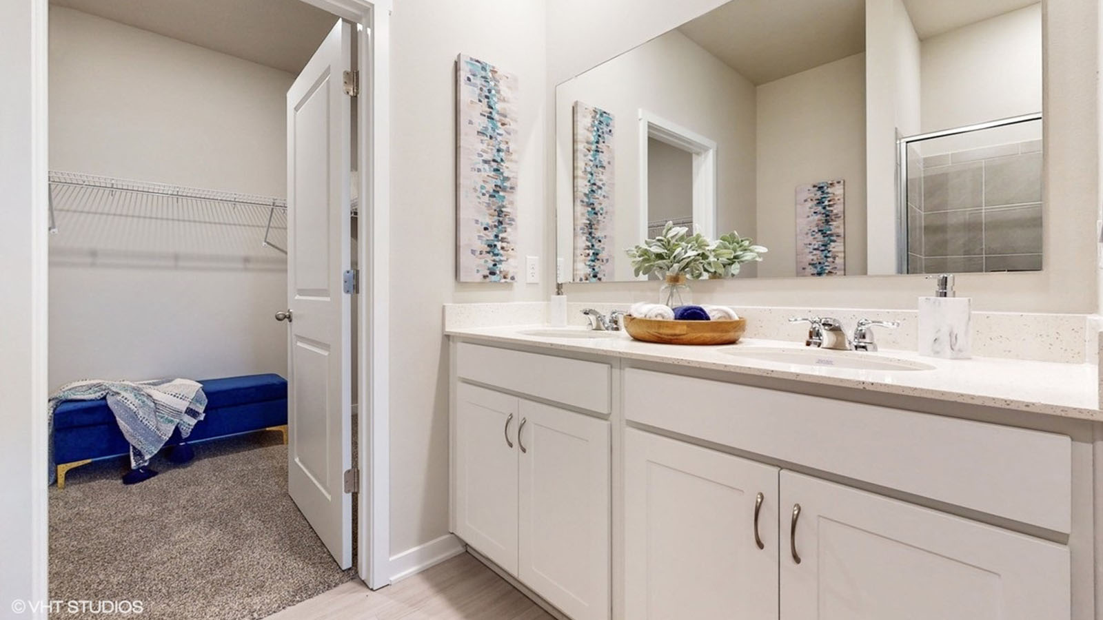 Primary bathroom with white cabinets and dual sinks